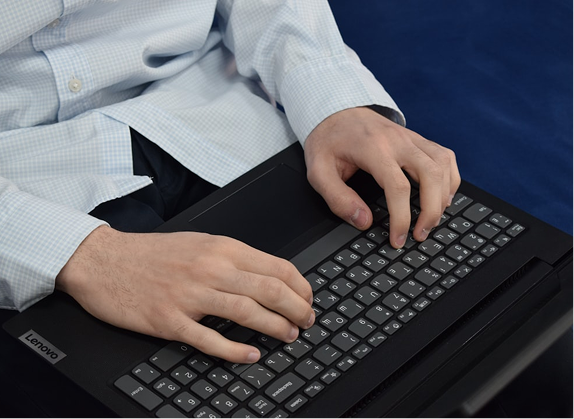 Image (Professional typing on laptop)